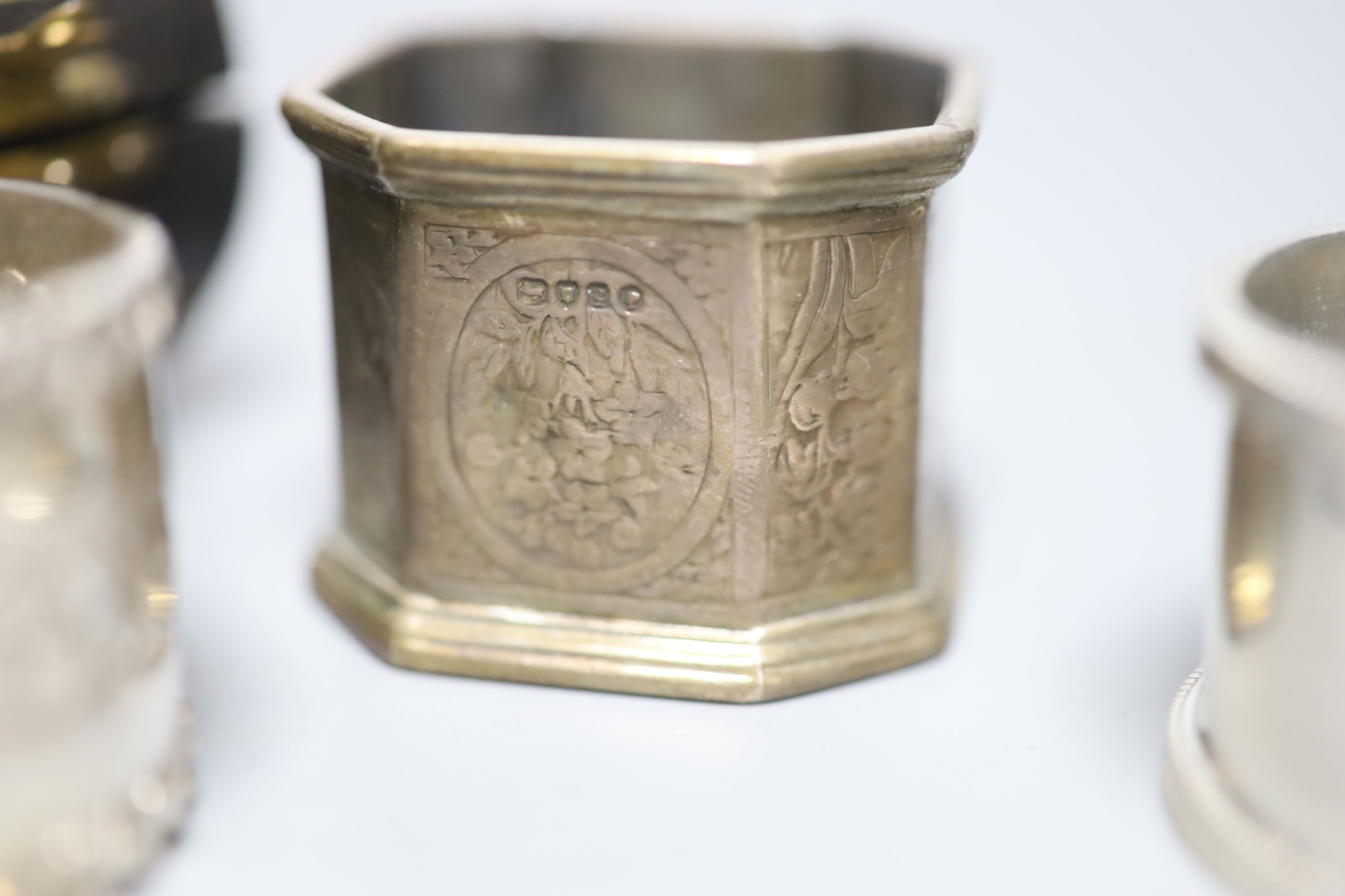 A cased late Victorian silver napkin ring, one other similar pair and a later silver napkin ring